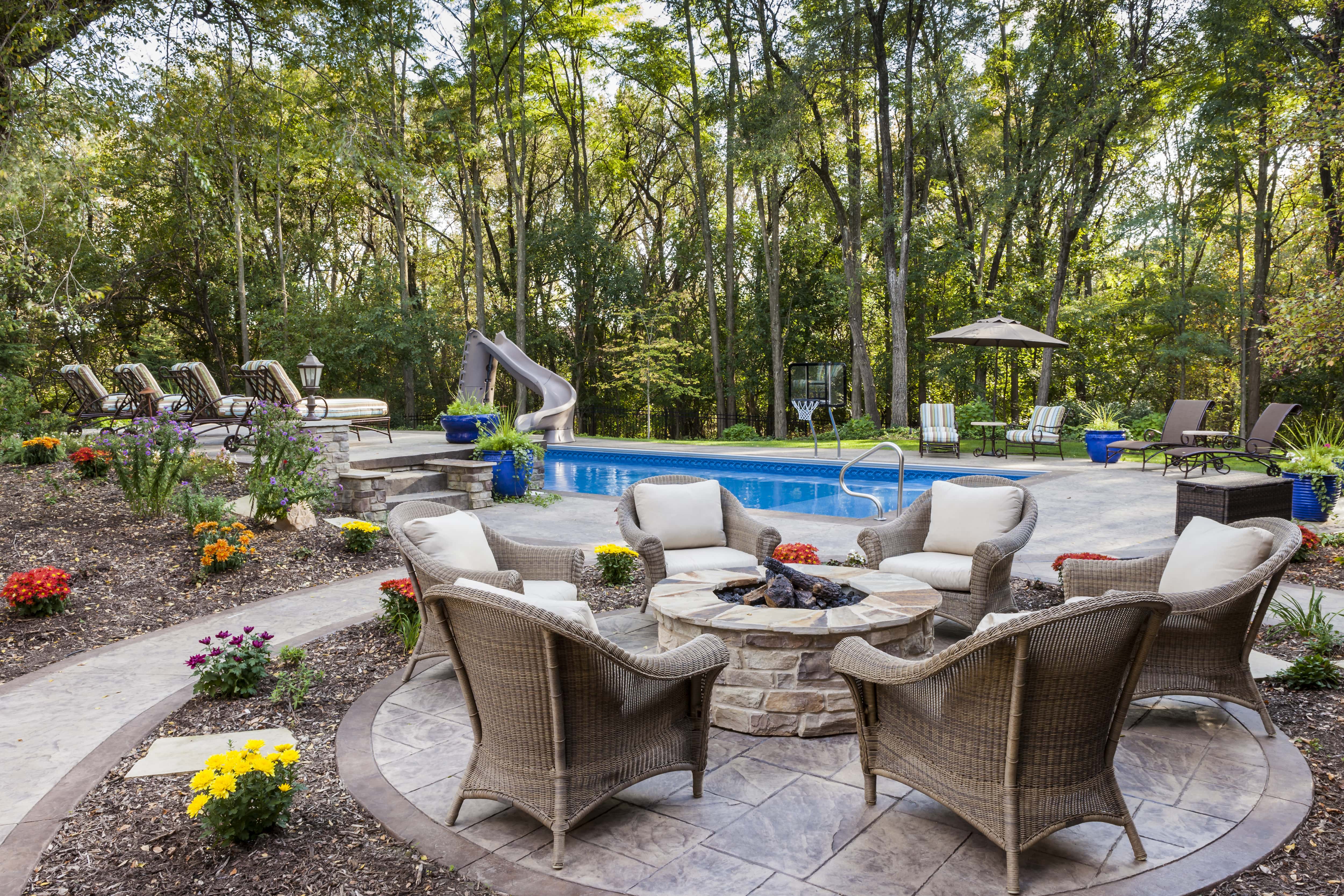 Wicker patio chairs centered around fire pit