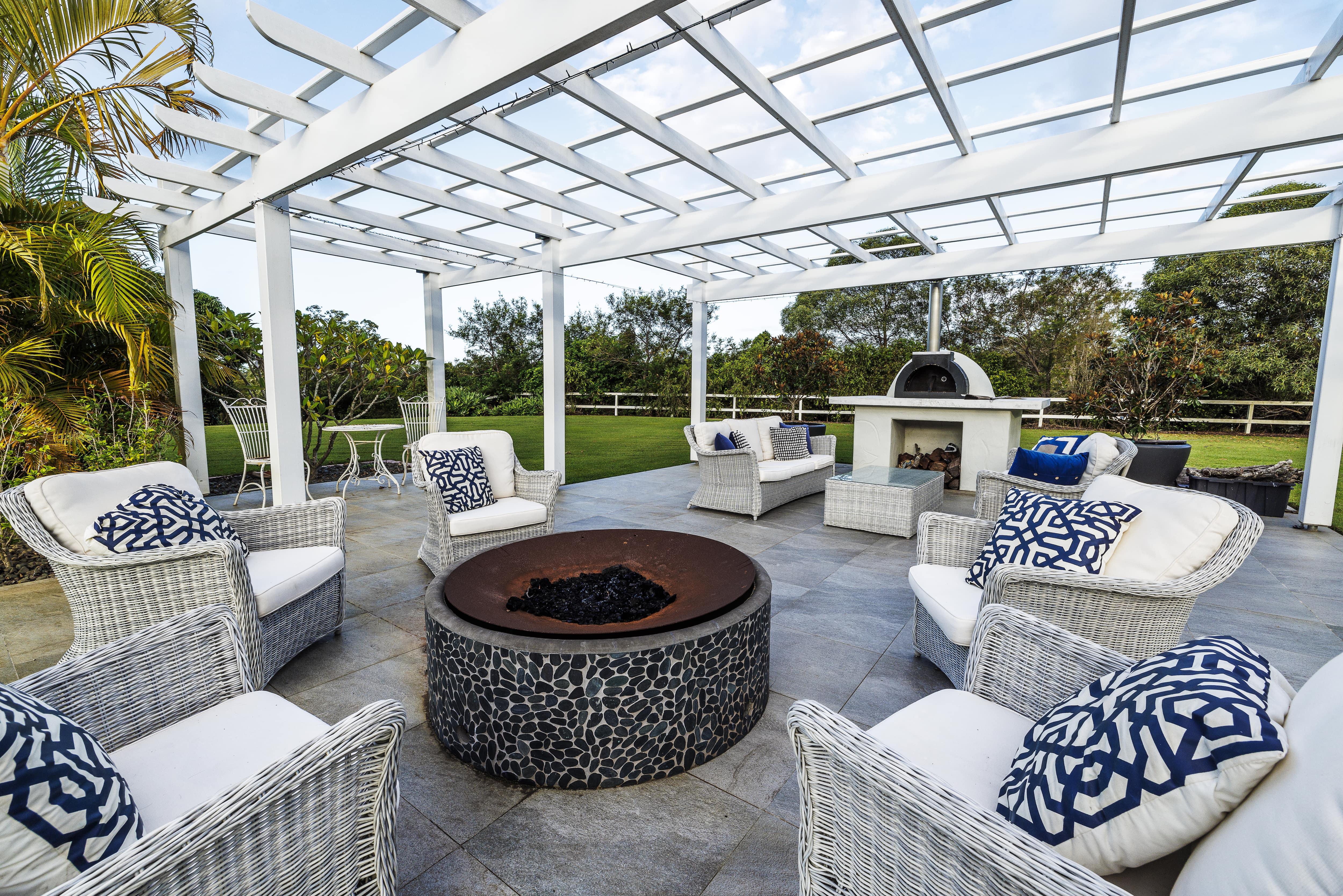 Light gray wicker chairs with blue and white throw pillows