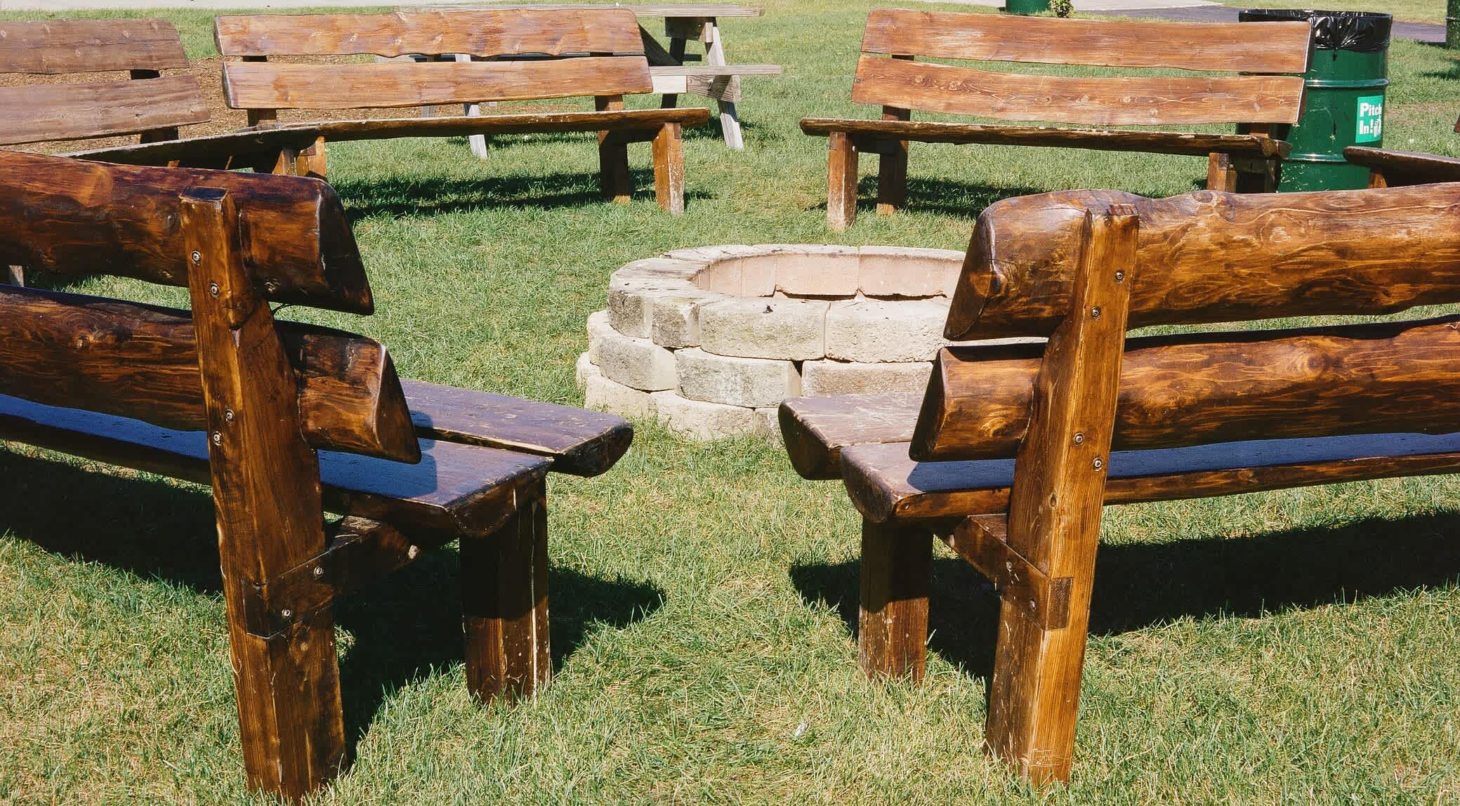 Wooden benches surrounding stone fire pit