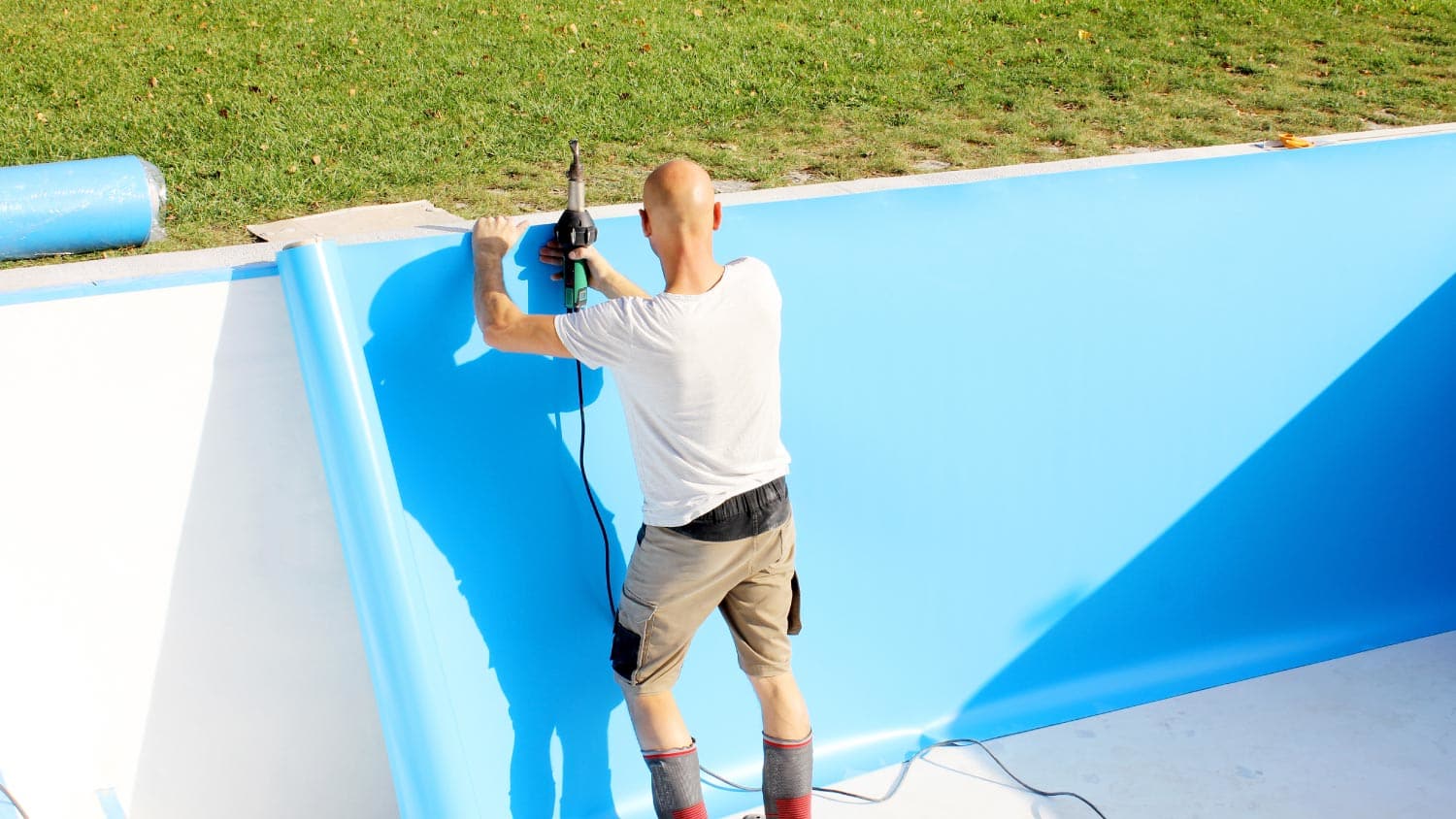 A man replacing a pool liner