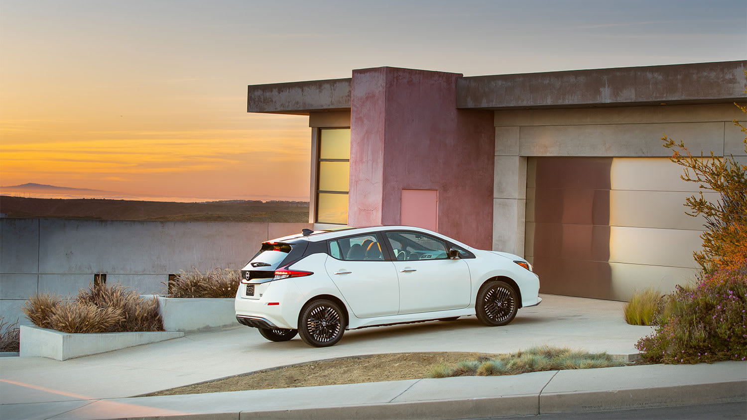 A view of a 2023 Nissan Leaf in a driveway