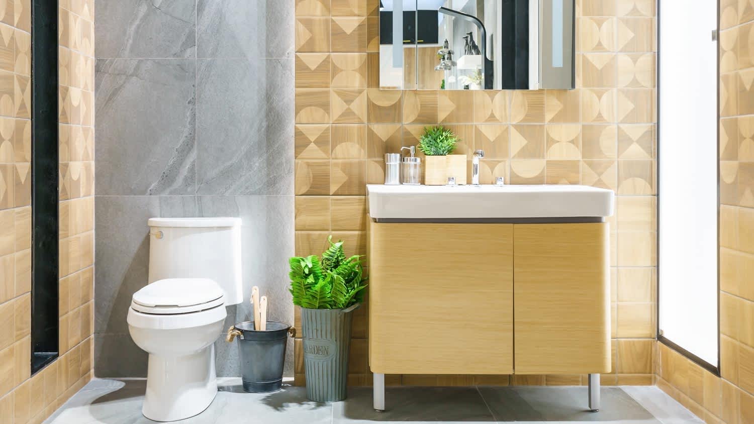 A modern bathroom with a wooden sink and a white toilet bowl