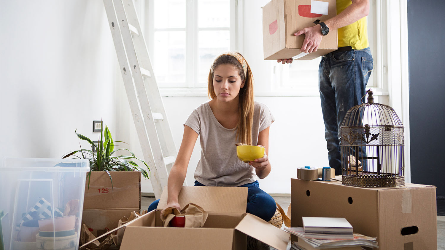 couple unpacking boxes after moving in