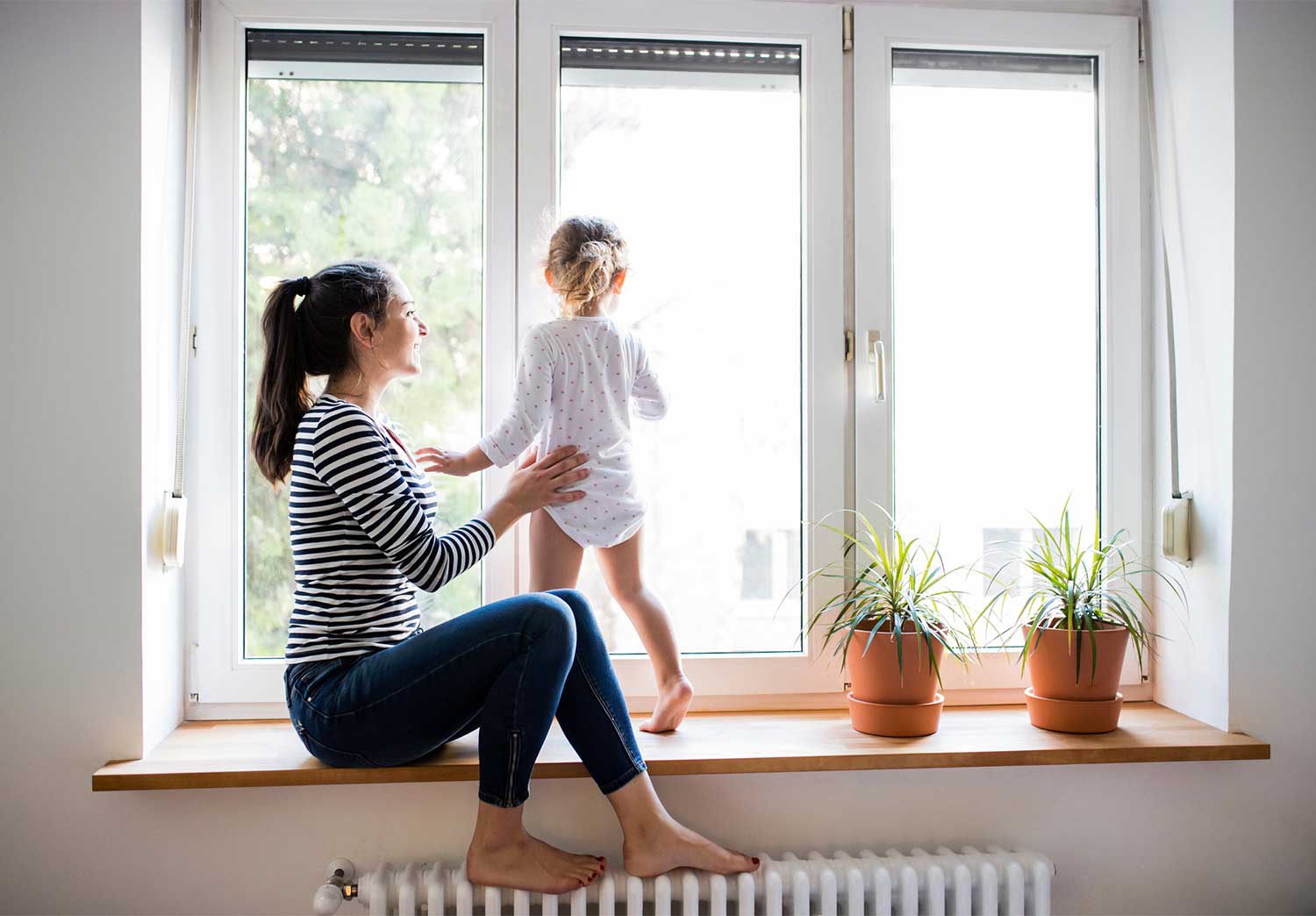 Mother and daughter looking out the window