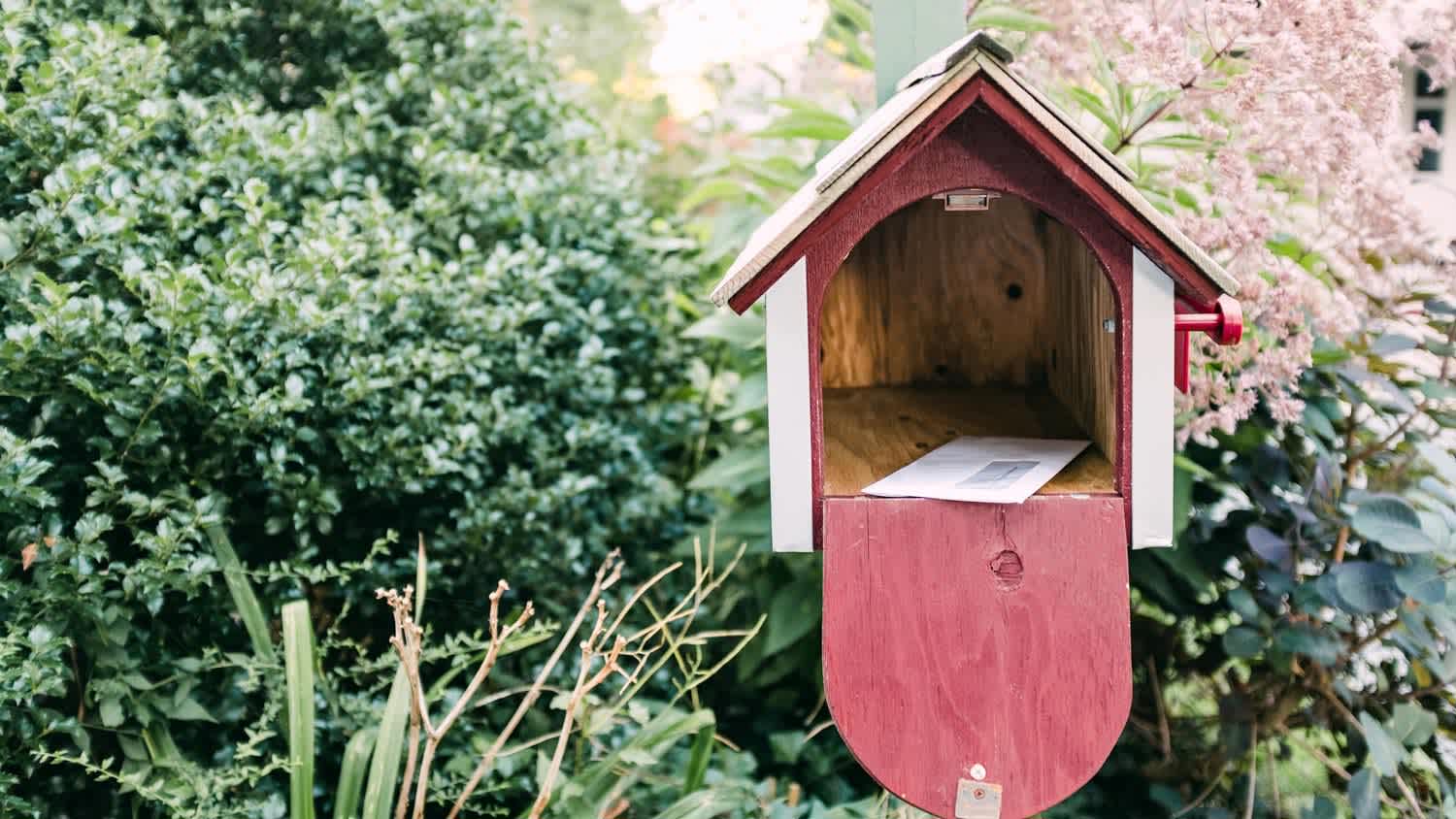 A house shaped wooden mailbox