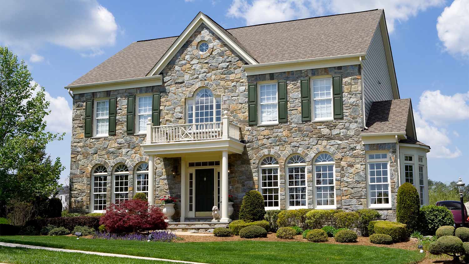 Stone colonial house and landscaping
