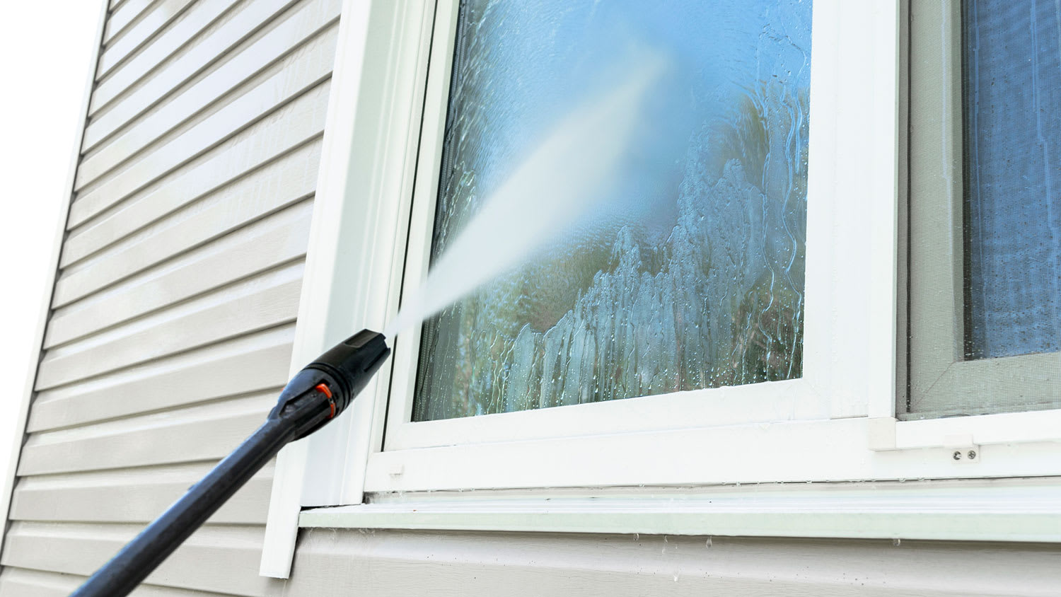 Washing building facade and window with pressure water