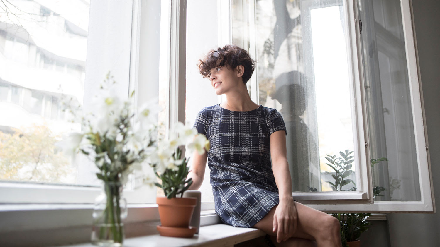 woman reading a book by the window