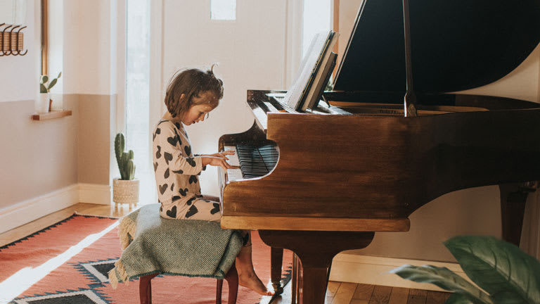 little girl playing piano