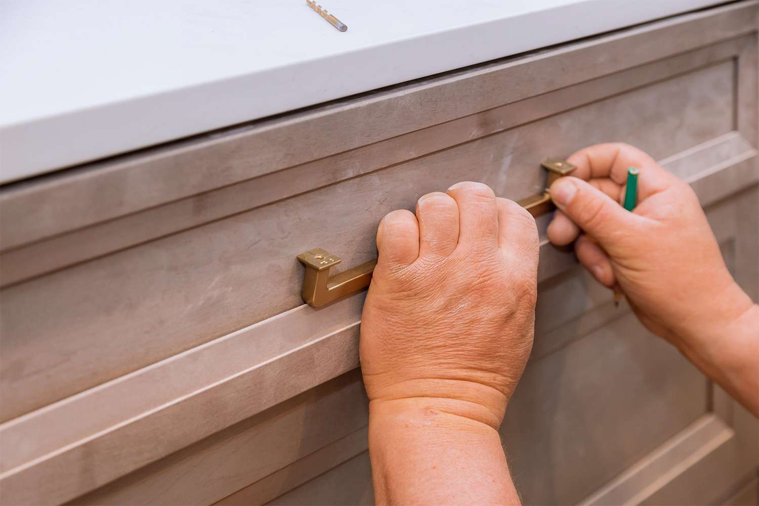 Man preparing to install new kitchen hardware