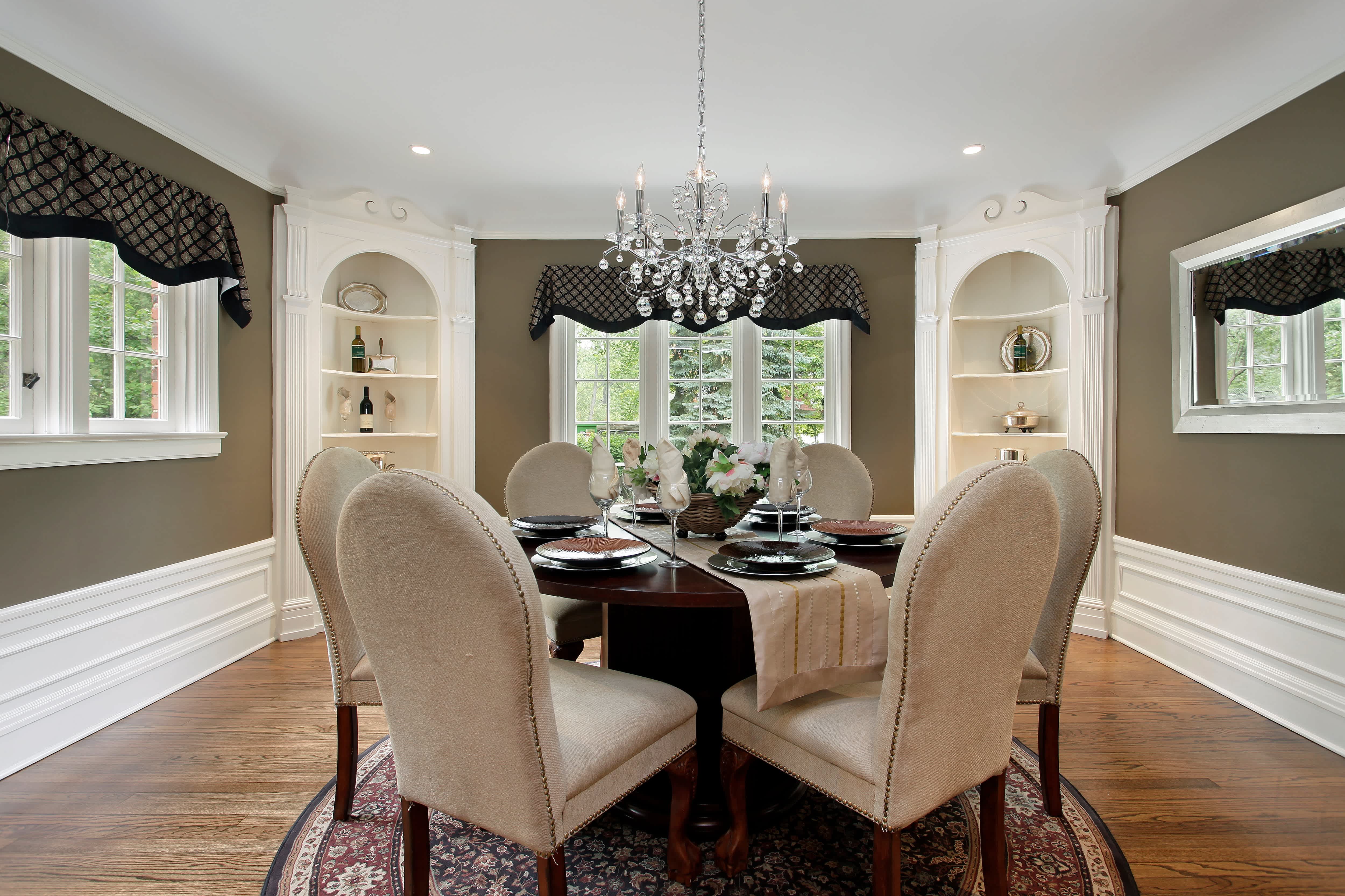 A modern dining room with a classic glass chandelier with bubble glass accents