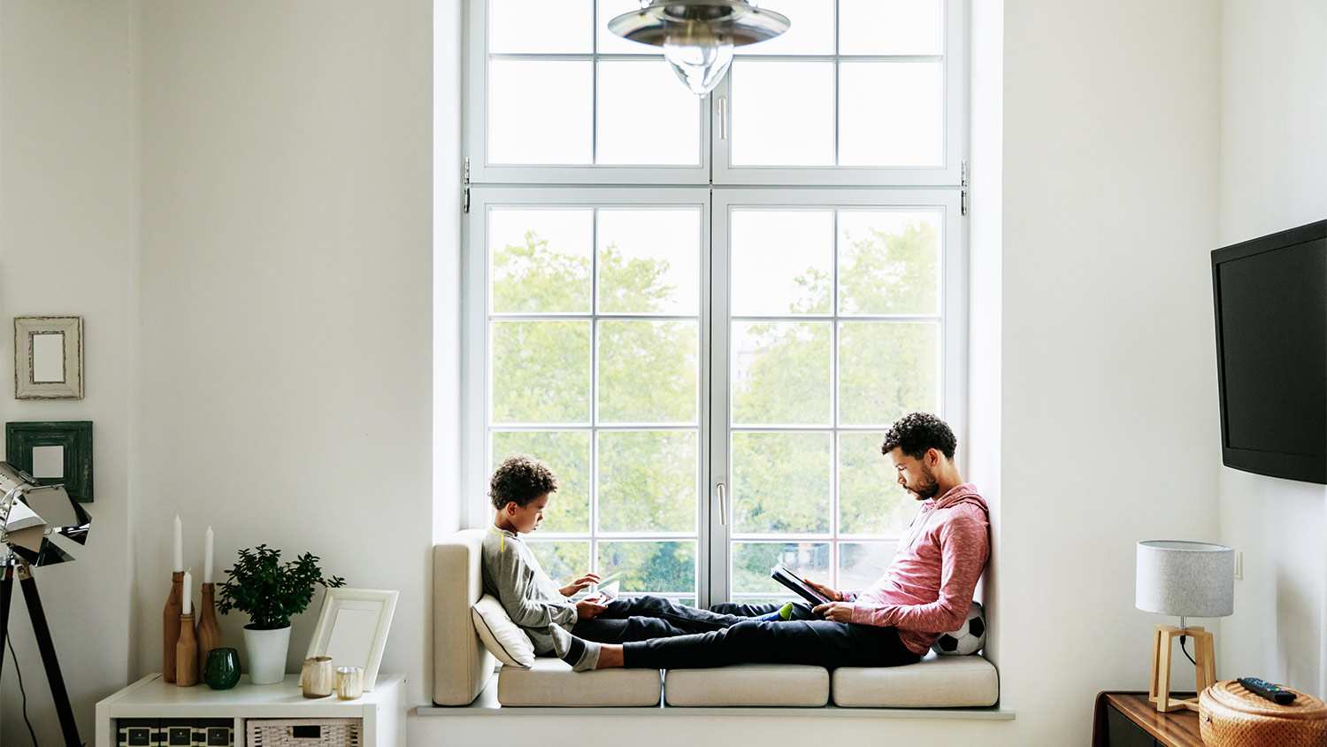 Family sitting in large window seat