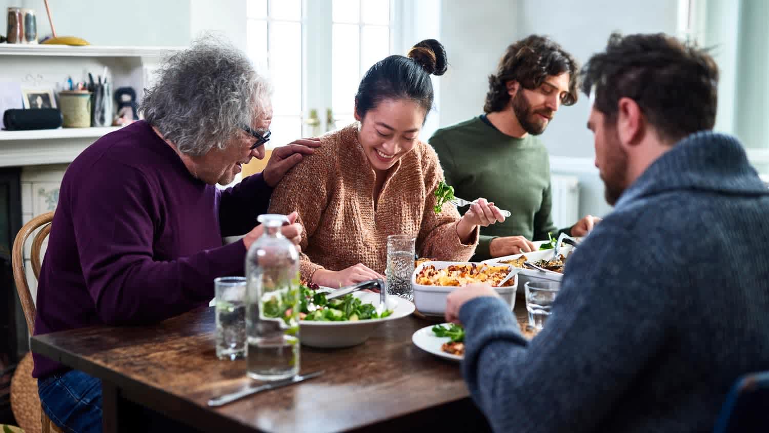 A family enjoying dinner on a wooden table