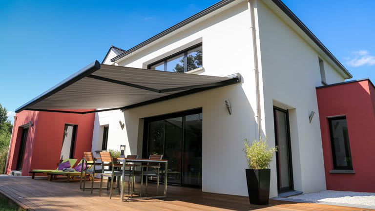 modern home backyard patio with awning