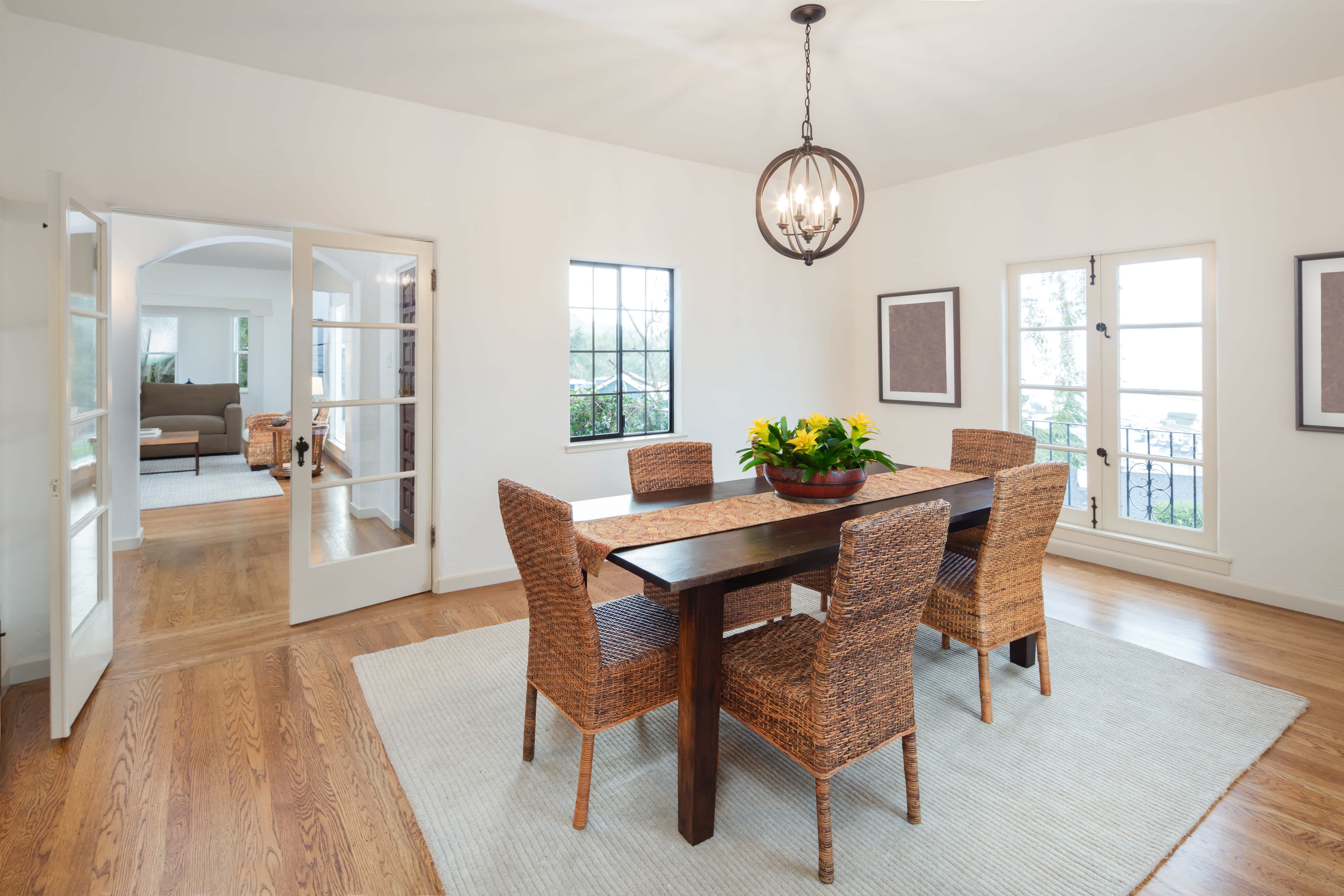 Modern dining room with board and batten walls and a simple orb cage chandelier