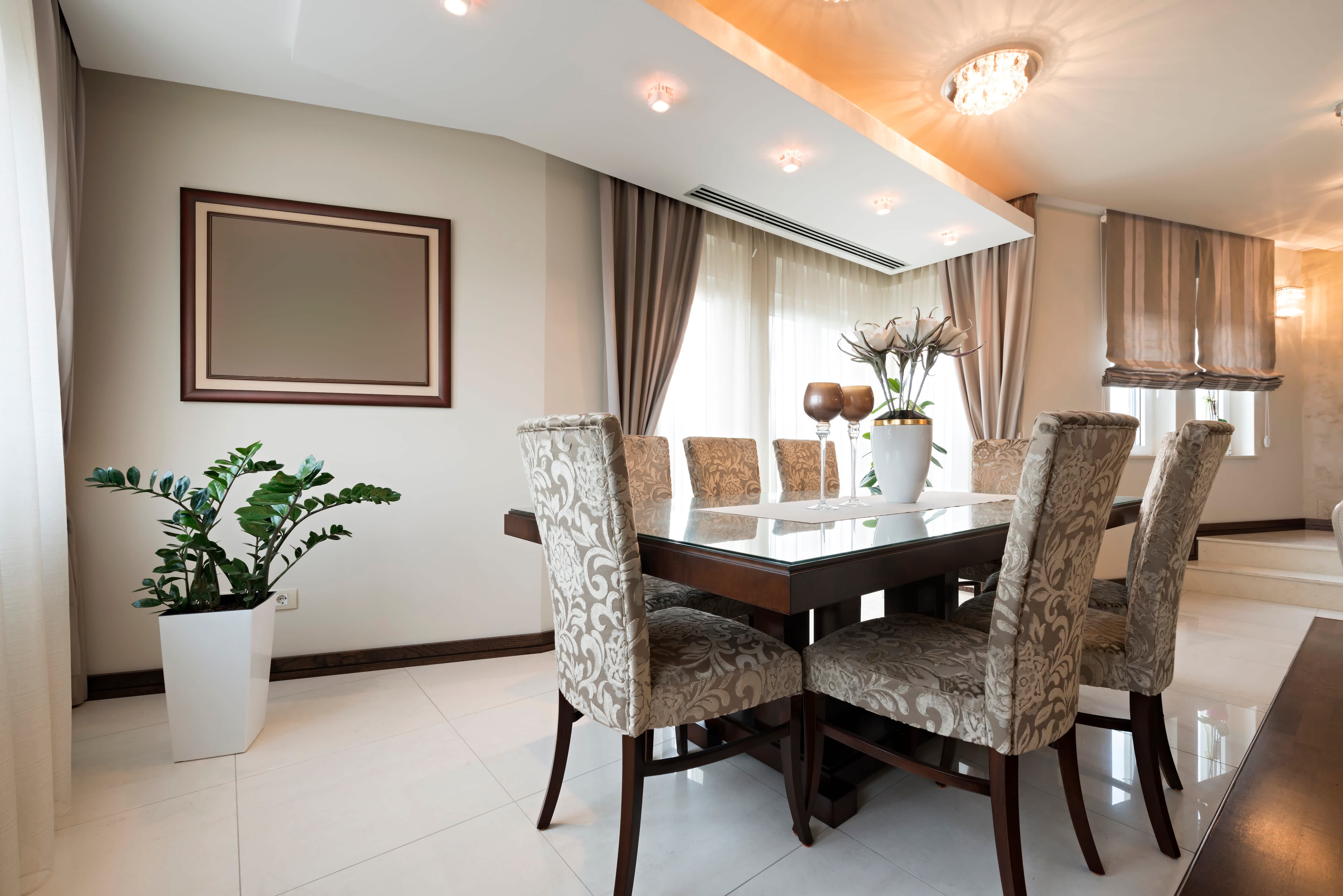 Modern gray-and-white dining room with recessed ceiling lights