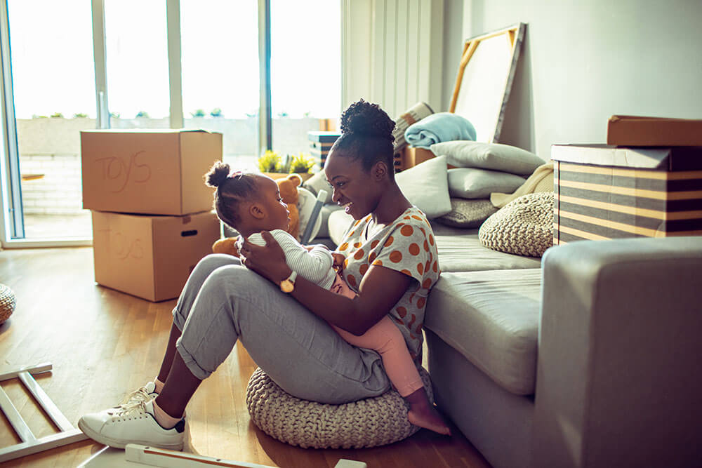 Mother playing with child while packing
