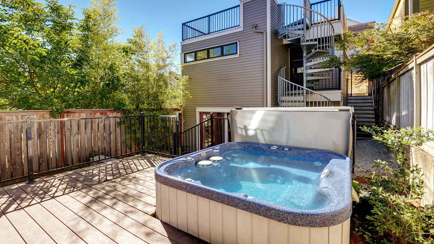 Small wooden walkout deck with hot tub