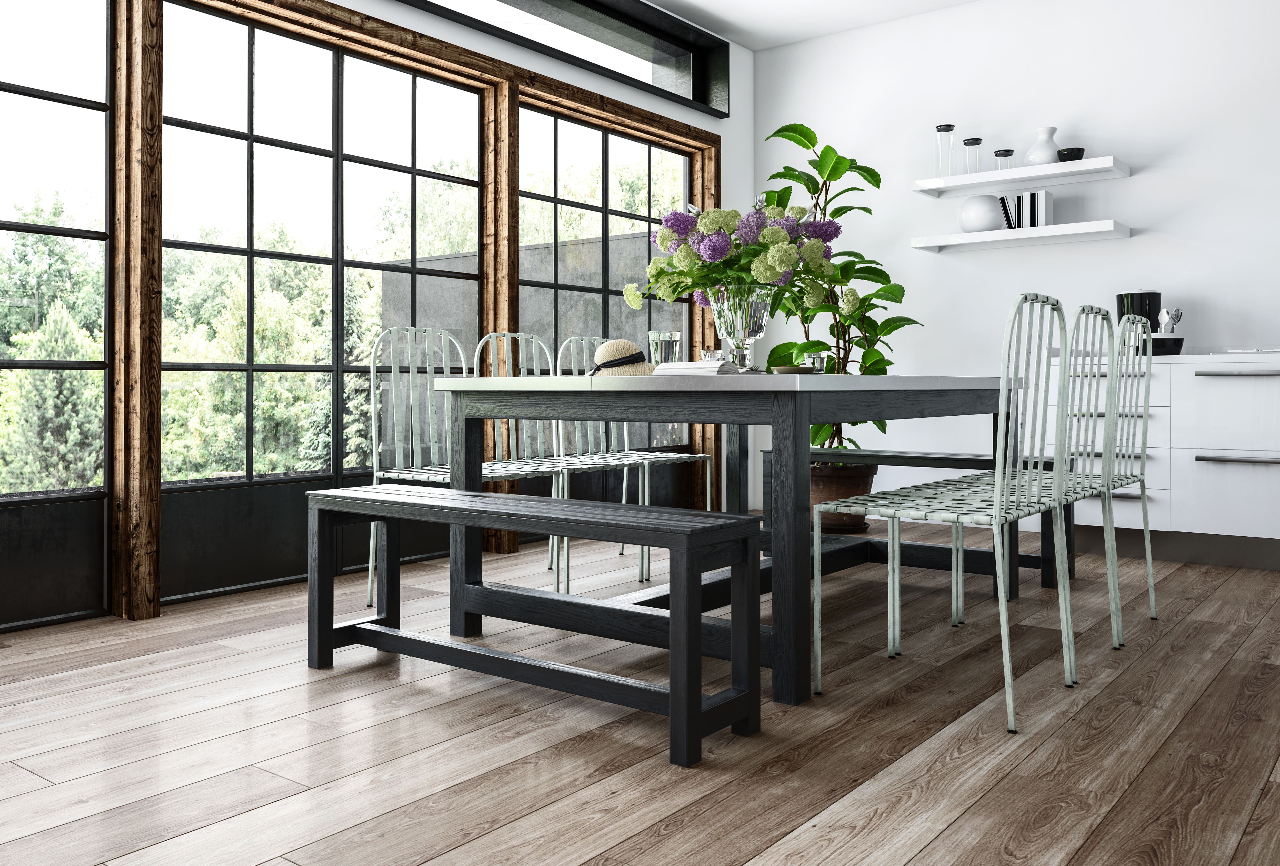 Minimalist dining room with gray dining room table, gray bench, and white woven chairs