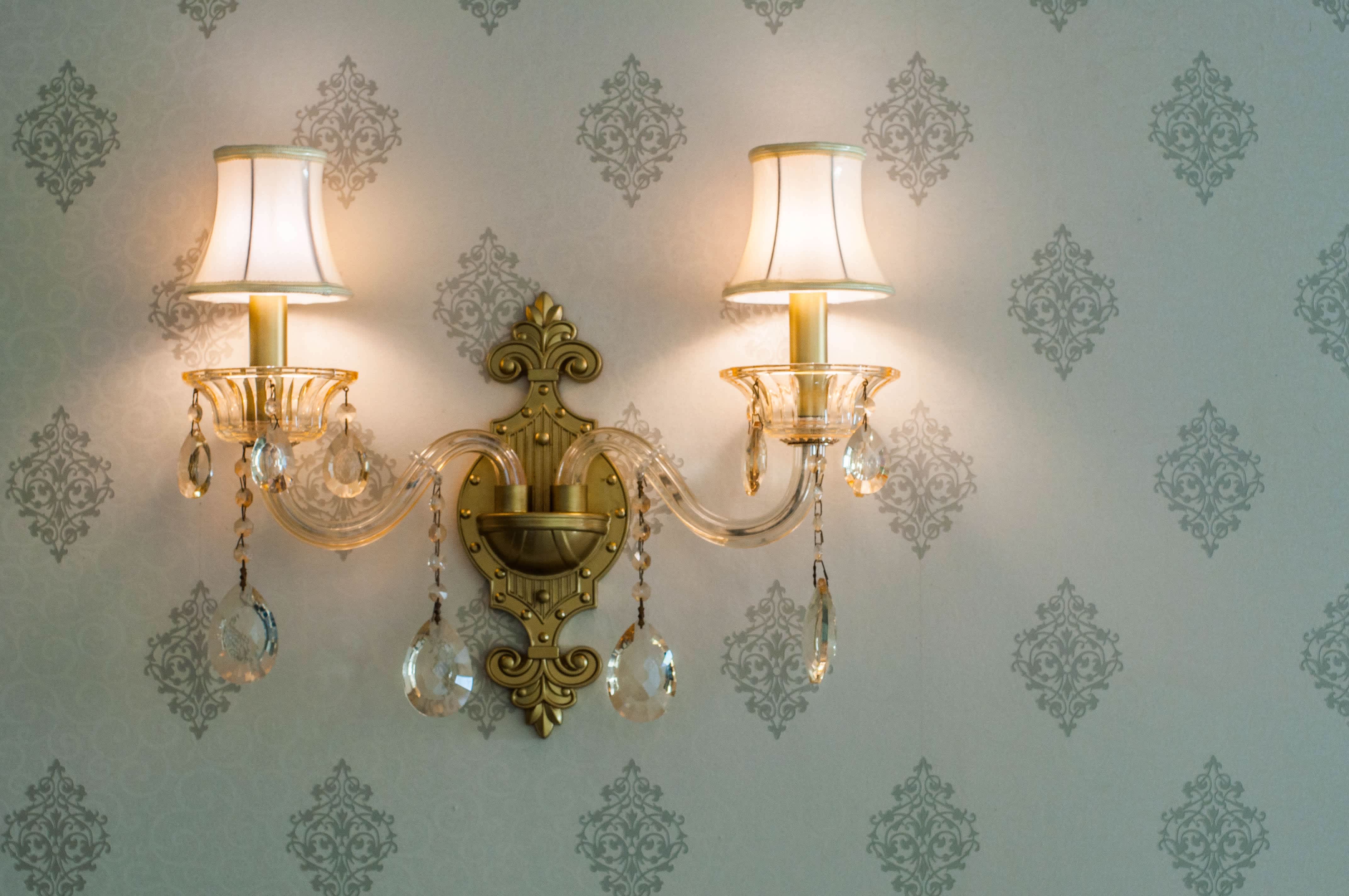 Two armed crystal flush mount wall sconce with crystal accents