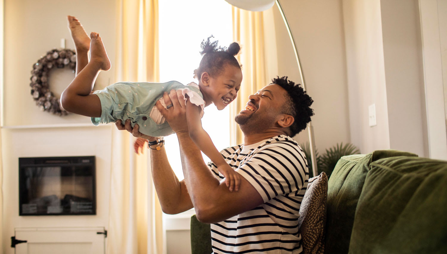 A father playing with his baby daughter
