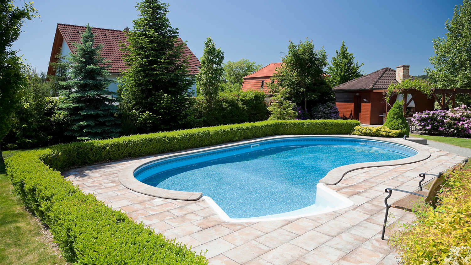 in ground swimming pool in large yard