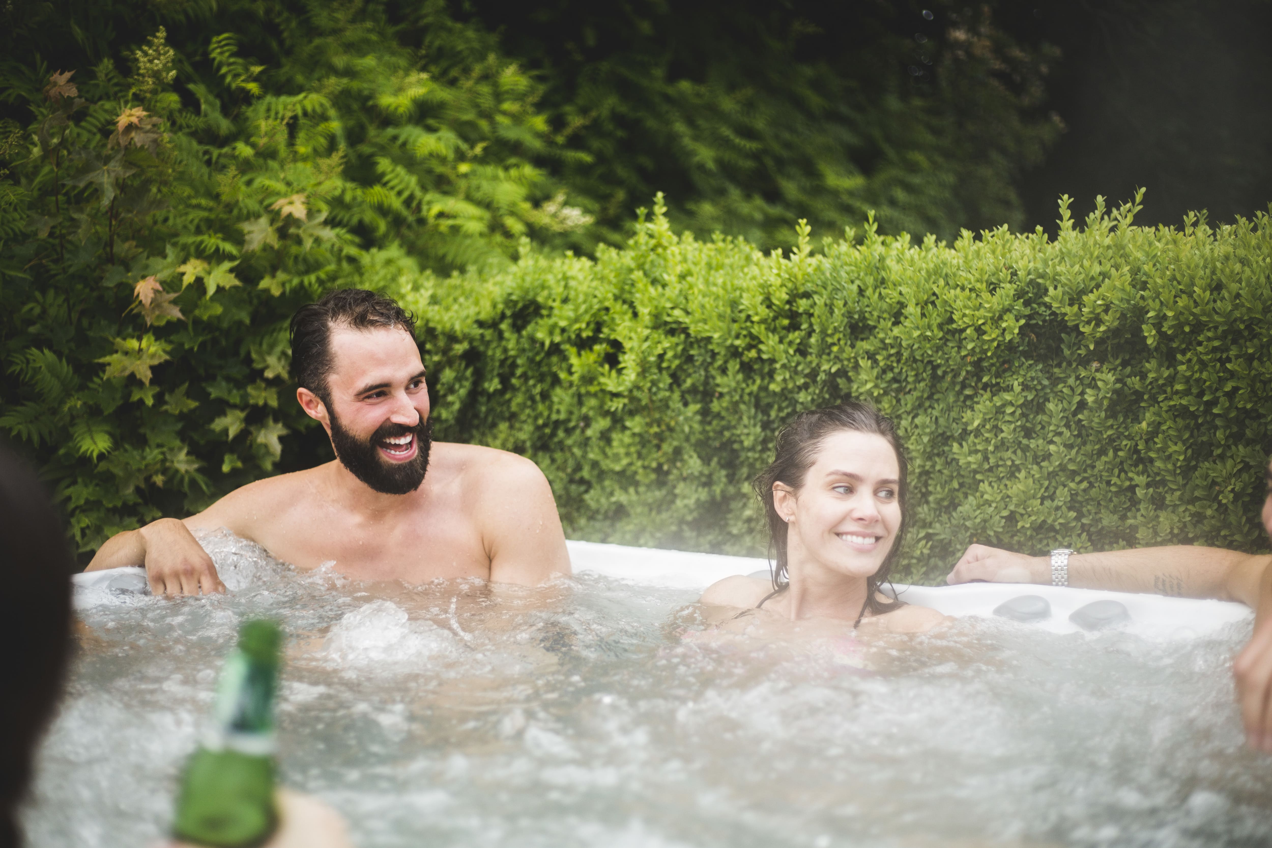 A group of friends smiling in a Jacuzzi