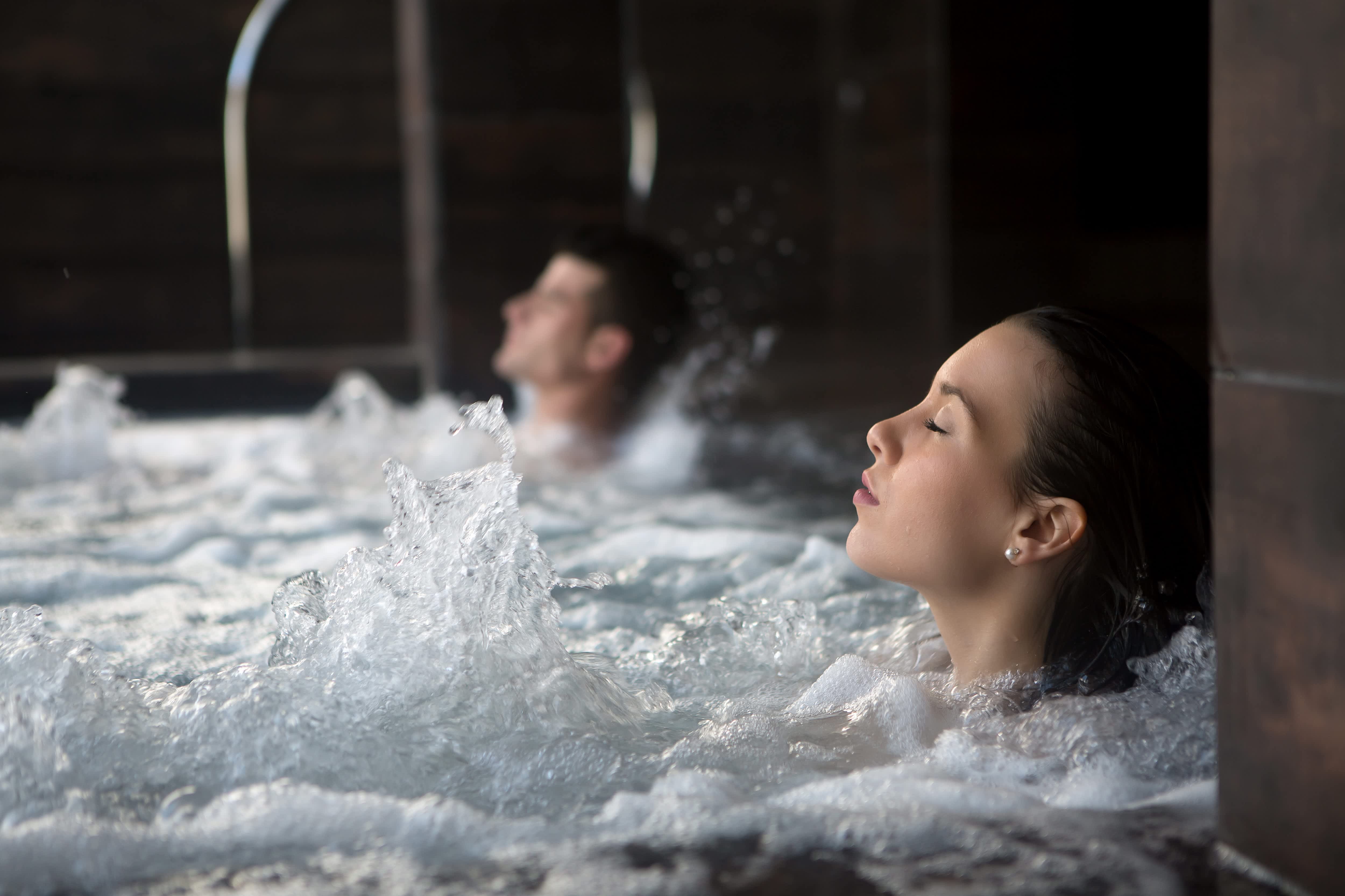 A couple relaxes in a spa bath