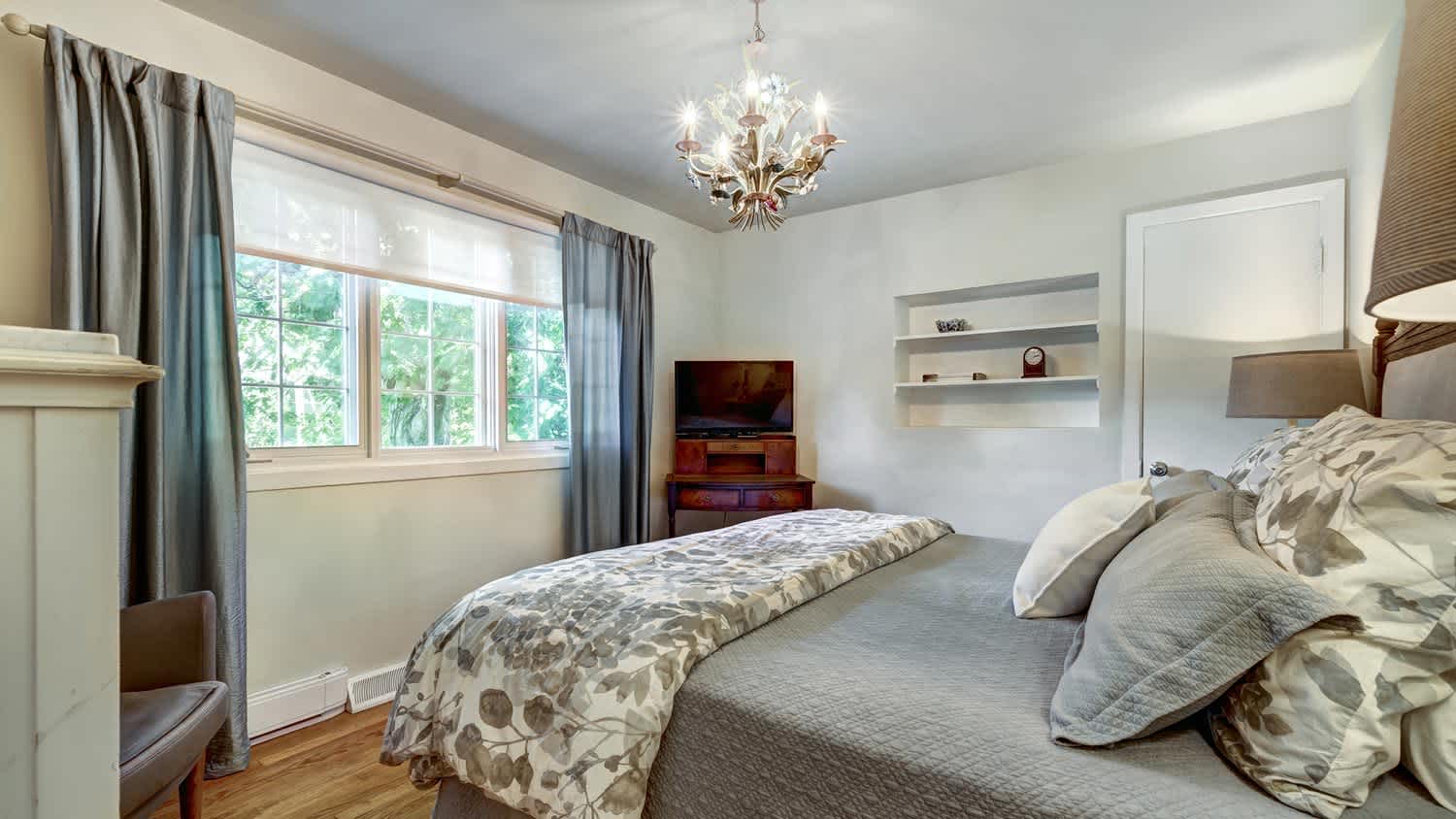 Lit up chandelier in a designer bedroom
