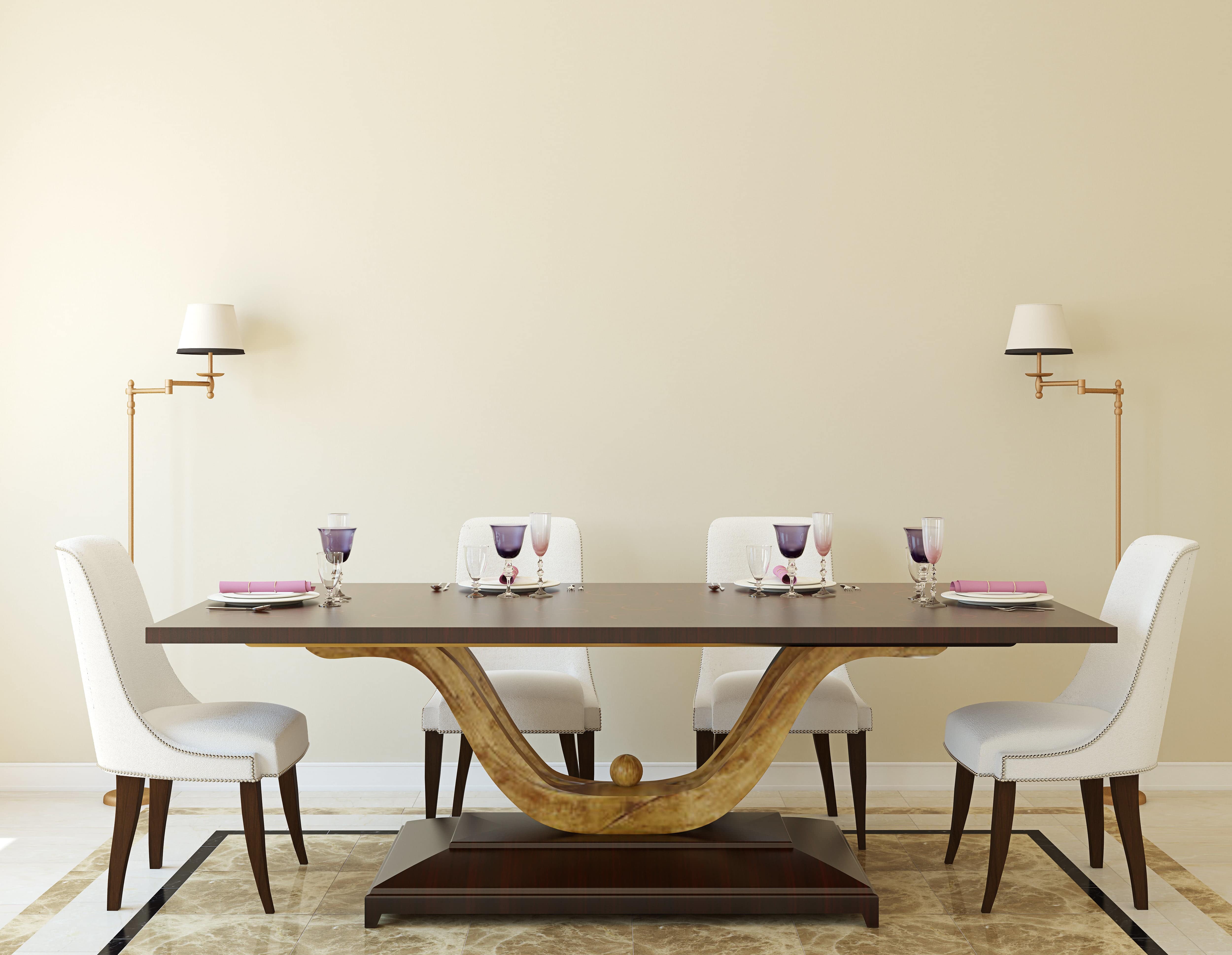 Dining room with contemporary wood table, white armless chairs, and tan walls