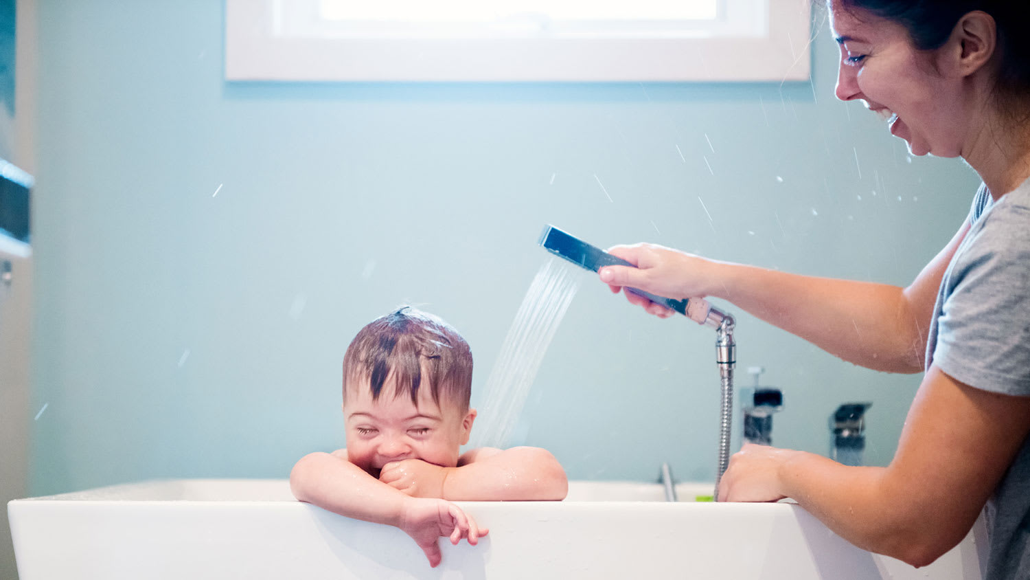 Mom bathing her toddler son