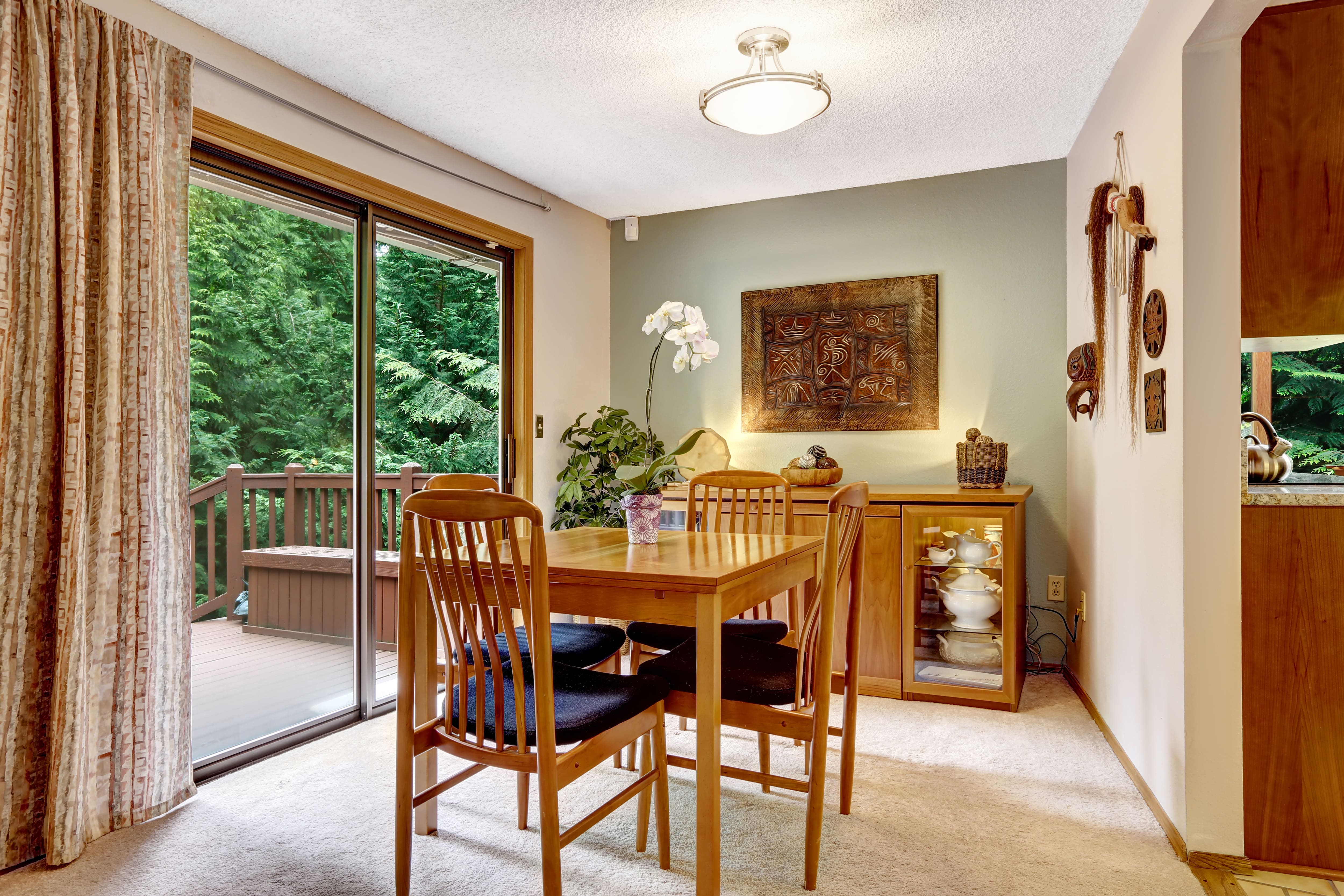 A cozy dining room with a semi-flush mount light and wood accents