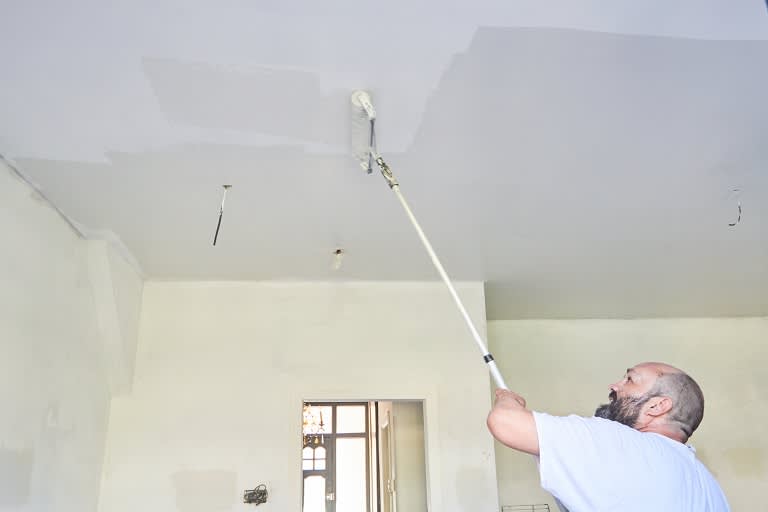 Painter painting house