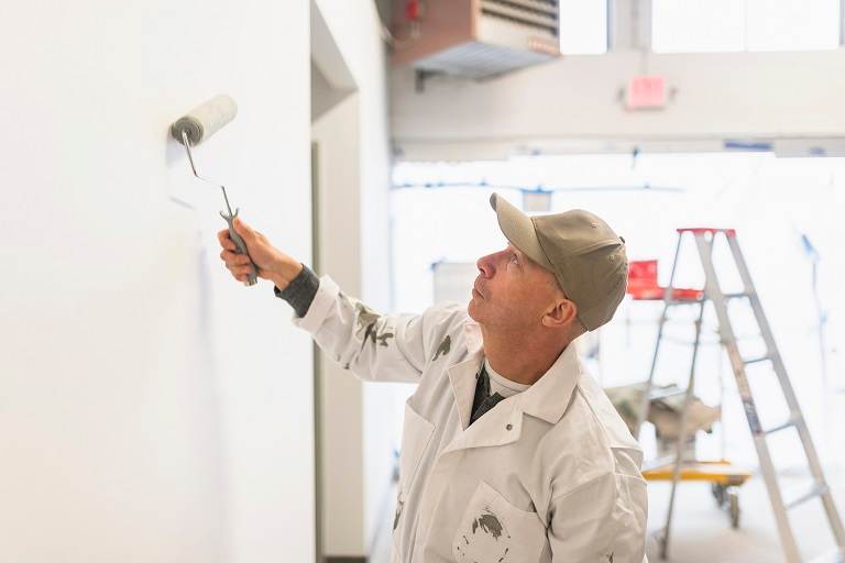Contractor painting wall