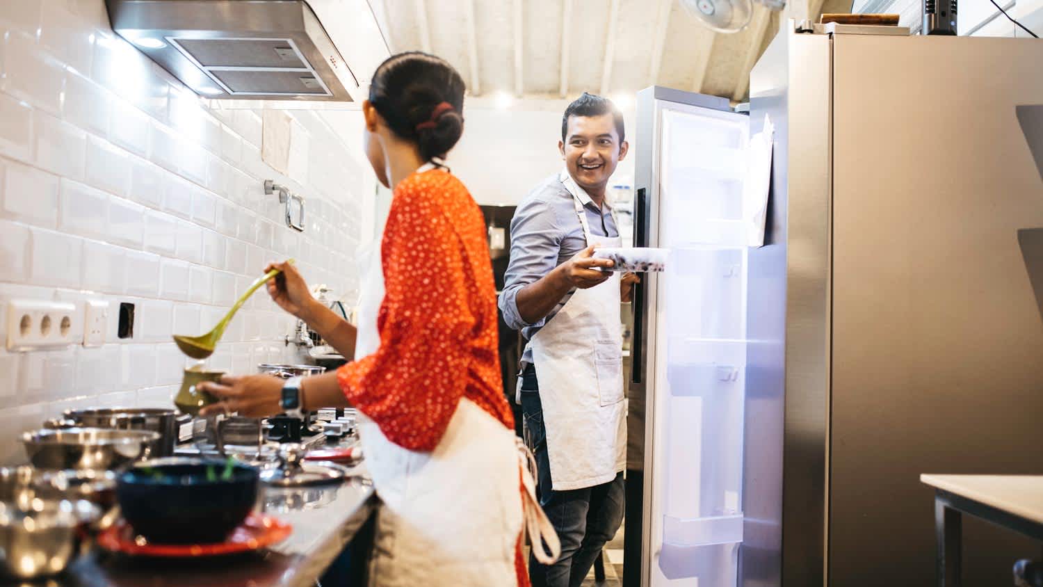 A couple cooking in the kitchen