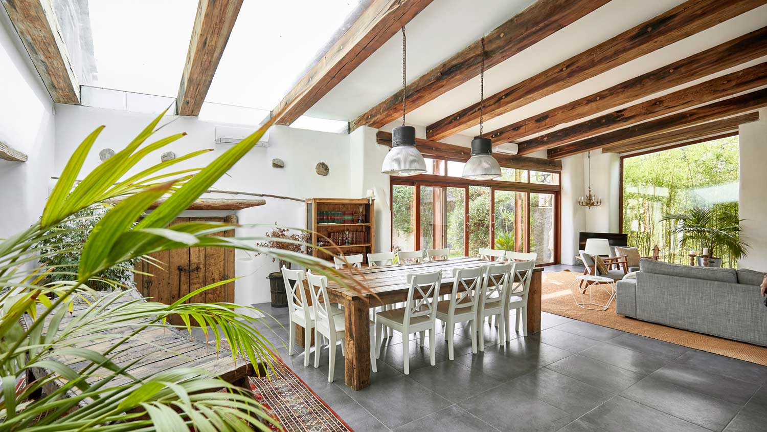 A spacious dining area in a bright farmhouse