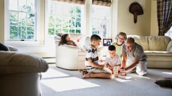Family laying on the carpet and playing a game