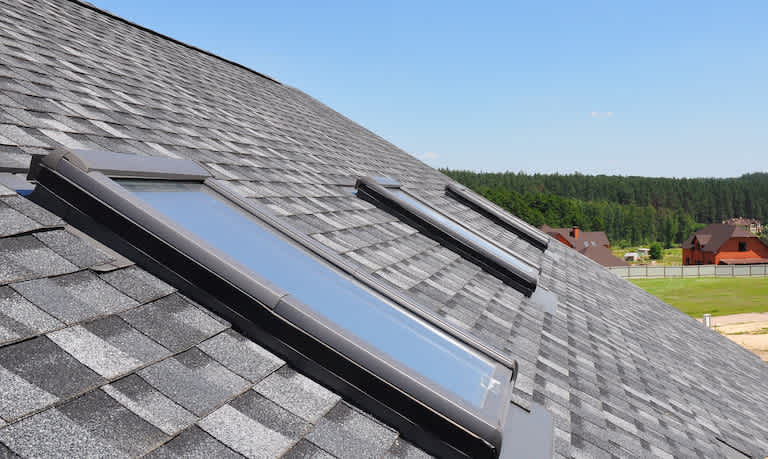 three skylight windows on the roof of a house