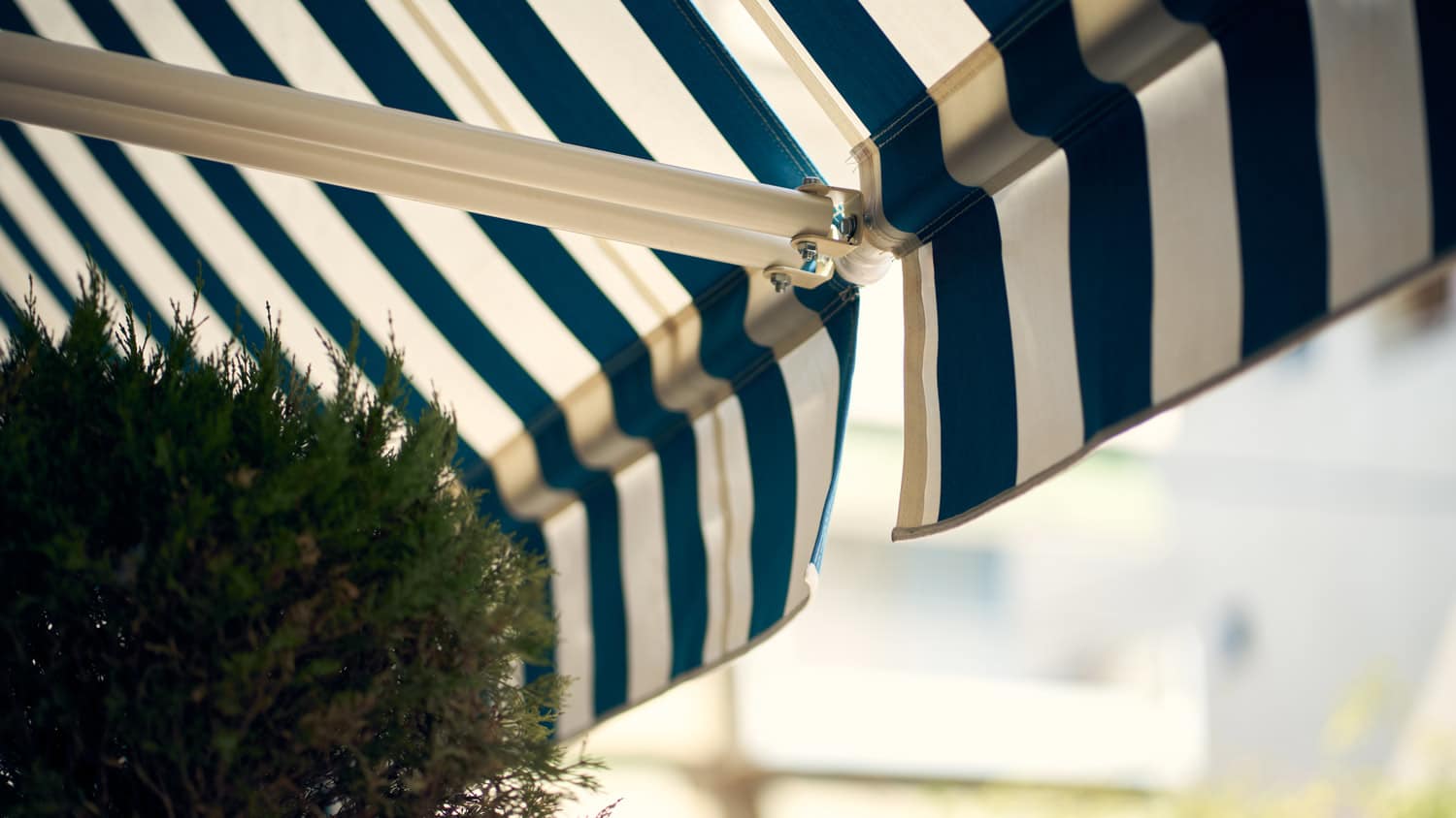 Detail of blue and white retractable awnings
