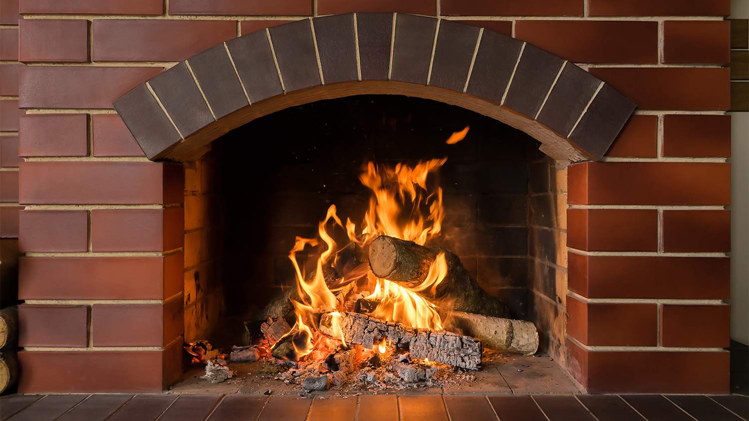 wood burning red brick fireplace