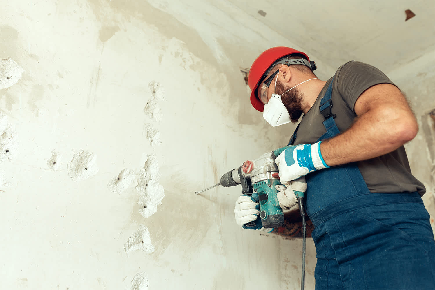 Professional preparing concrete wall to be demolished