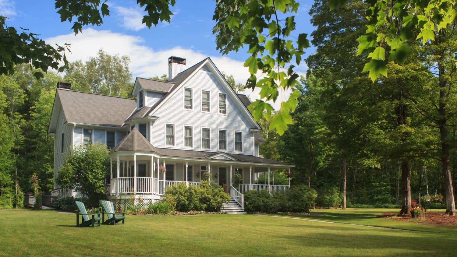 Victorian home with lawn and large front porch