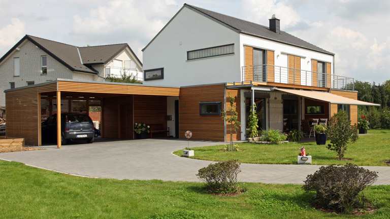 A carport situated next to a detached house