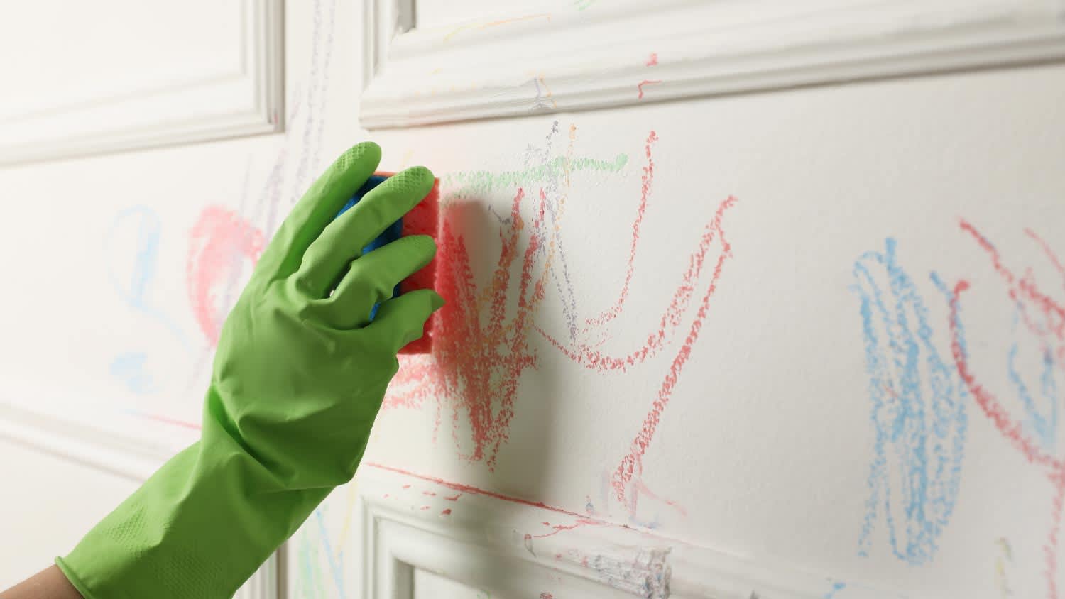 Woman cleaning white wall