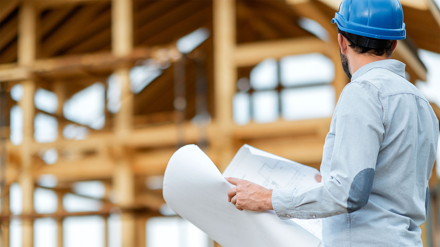 A contractor in front of a new construction
