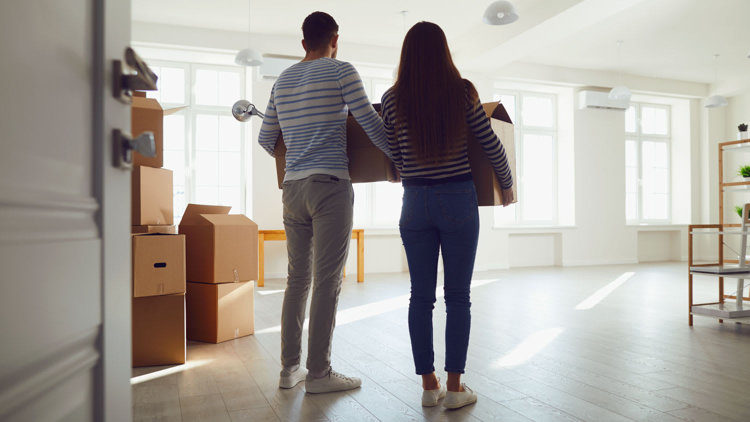 couple carrying moving boxes