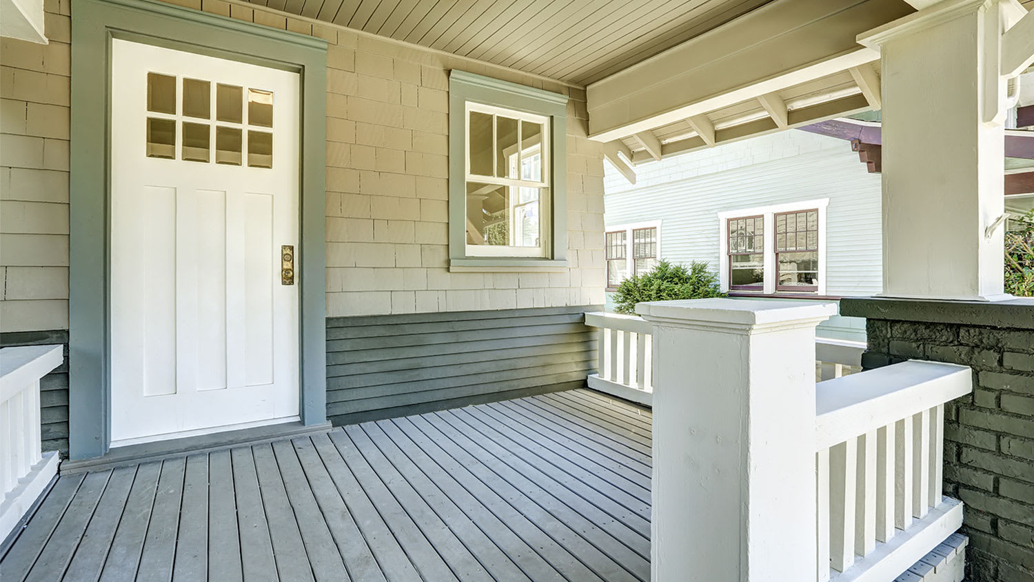 entrance porch with white door and green frame