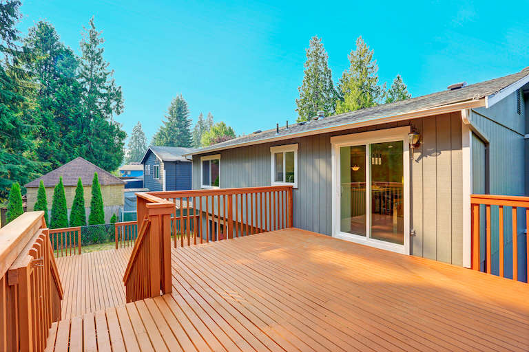 empty finished deck with double glass doors leading to home
