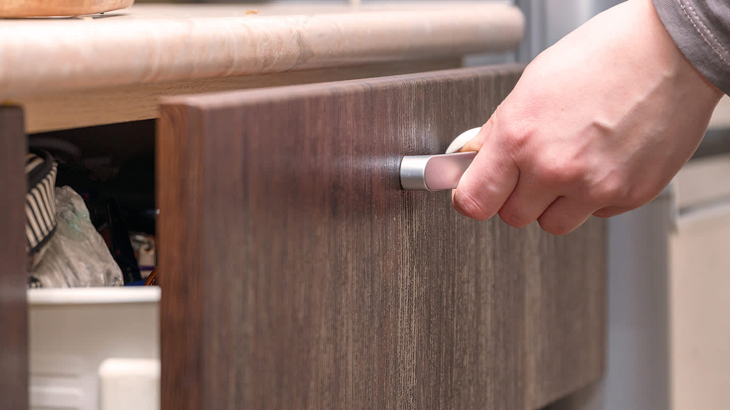 Closeup of closing a drawer in bathroom