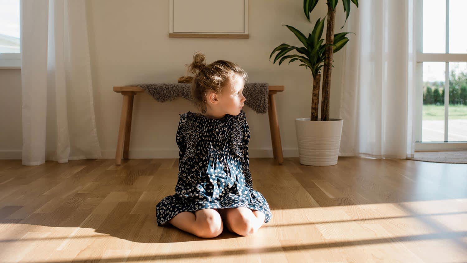 A young girl sitting on the floor